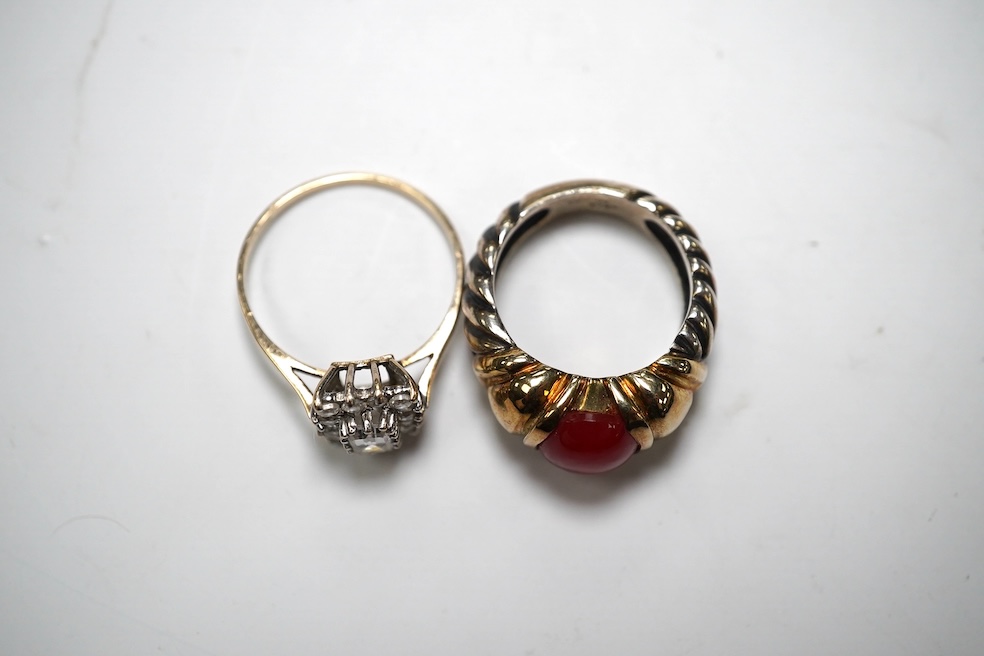 A gold and simulated diamond cluster set ring and a 14k and sterling set ring with cabochon stone. Condition - fair